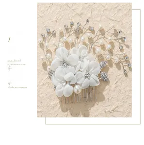 Detailed view of handmade bridal hair comb with white fabric flowers and rhinestones