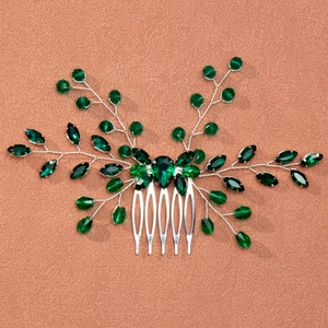 Detailed view of handmade silver bridal hair comb with dark green crystals and leaf design