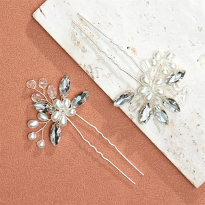 Detail of silver U-shaped hair pins with white pearls and sparkling crystal flowers