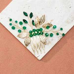 Exquisite bridal hair comb with gold leaves and dark green crystal beads on white stone