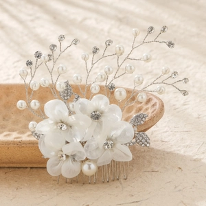 Elegant bridal hair comb with white tulle flowers, pearls, and rhinestones for weddings