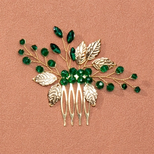 Handmade bridal hair comb with gold leaves and dark green crystal accents for weddings