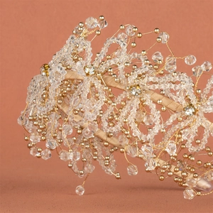 Exquisite bridal headband with handmade crystal beads and gold wire on red background