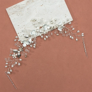 Elegant bridal hair vine with white pearls and crystal flowers for wedding styling
