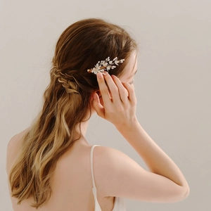 Handmade ceramic flower hair clip with golden branches for elegant bridal hairstyles