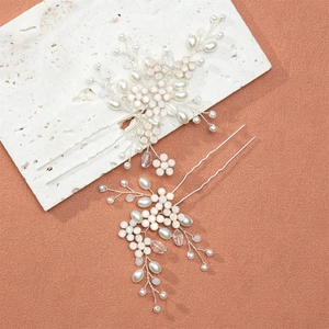Close-up of handmade bridal hair pins with white pearls and sparkling crystal beads