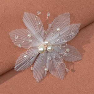 Detail of delicate mesh flower hair clip with pearls and crystal beads on gold wire