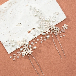 Detail of silver bridal hair pins with handmade pearls, crystals and floral vine design