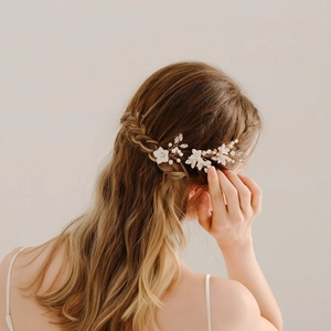 Handmade bridal hair pins set with ceramic flowers pearls and rhinestones on braided hair