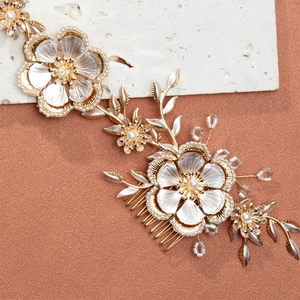 Elegant bridal hair comb with vintage metal flowers pearls and crystal beads on textured stone