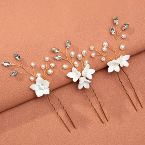 Elegant bridal hair pins set with handmade white ceramic flowers and pearls on gold wire