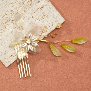 Elegant floral hair comb with pearls and leaves for traditional bridal hair styling