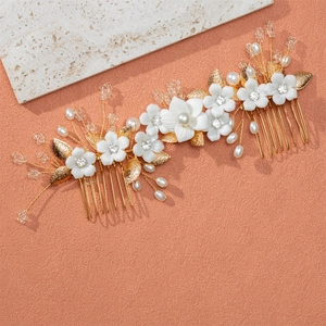 Handmade bridal hair combs with white ceramic flowers and pearls on golden alloy base