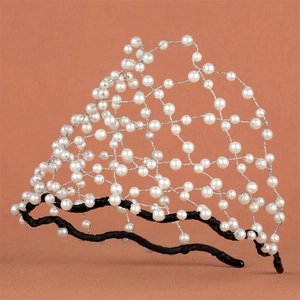Detail of bridal headband featuring handcrafted white pearls woven on a black metal base