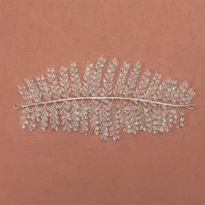 Detailed view of hand-woven silver wire headband with clear beaded leaf patterns