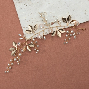 Detail of handcrafted gold bridal headband with pearls, golden leaves and pink flowers