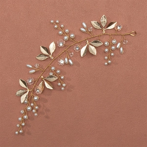 Handmade golden bridal hair band with white pearls and delicate metallic leaves