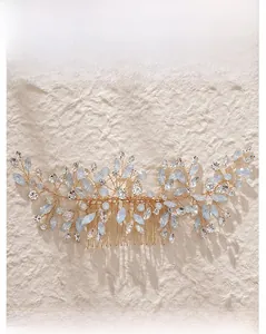 Detail of bridal hair comb with gold wire, light blue beads and faceted clear crystals
