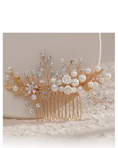 Detailed close-up of golden bridal hair comb with pearls and rhinestones on stone base