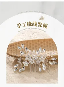 Detail of handmade bridal hair comb with silver wire, sparkling crystals and white pearls