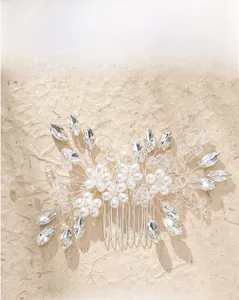 Close-up of bridal hair comb with marquise crystals, faux pearls, and silver floral wire work