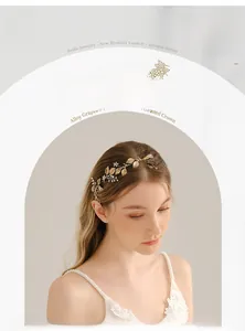 Detail of bridal headband with golden alloy leaves, rhinestones, and pearls on model