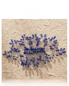 Close-up of handmade bridal hair comb with blue crystals and silver wire details