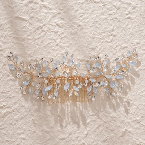 Elegant gold bridal hair comb featuring leaf design with rhinestones and blue crystals