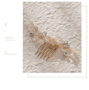 Detail of bridal hair comb with handmade pearls and sparkling rhinestones on gold wire
