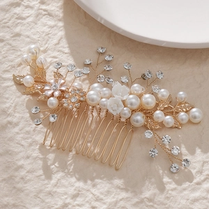Elegant gold bridal hair comb with pearls, crystals and ceramic flowers for wedding styling