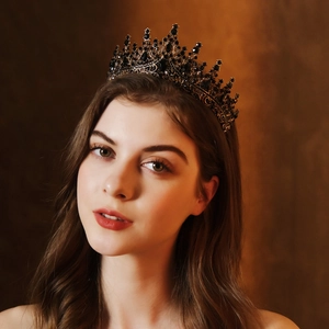 Baroque style bridal crown featuring black gemstones and bronze metalwork on model