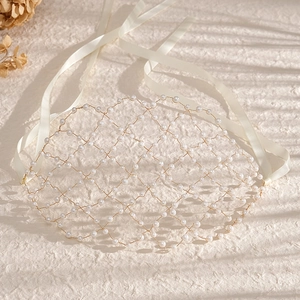 Elegant bridal headpiece with white pearls on golden wire and white satin ribbons