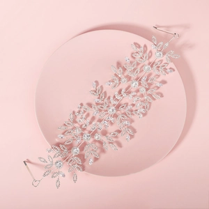 Luxurious bridal headband featuring silver leaves and rhinestones on a pink tray