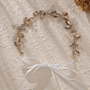 Elegant bridal hair vine with golden alloy leaves, rhinestones and white silk ribbons
