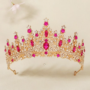 Macro detail of luxury bridal crown with rose red crystals and intricate gold metalwork