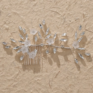Detailed view of handmade bridal hair comb with acrylic flowers and marquise rhinestones