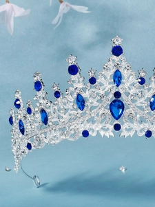 Detailed side view of Baroque crown with blue pear-cut gemstones and silver plating