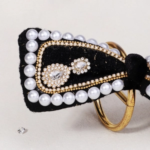 Elegant black velvet bridal hair clip with white pearl trim and sparkling crystal floral center