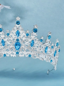 Detailed side view of luxury bridal tiara with silver base and blue water-drop crystals
