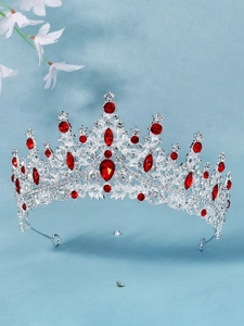 Detailed macro shot of bridal tiara with red teardrop gemstones and silver rhinestones