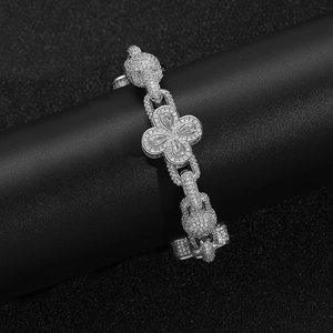 Macro view of silver clover bracelet with iced-out pave crystals and heavy chunky chain