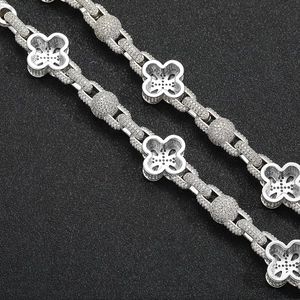 Detail of hip hop clover bead chain with micro-pave cubic zirconia on black background