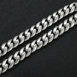 Macro close-up of high-polish Cuban link chain with 18k gold plating and 18mm cubic zirconia
