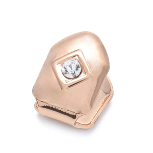 Rose gold hip hop grillz with a single sparkling cubic zirconia set in a diamond groove