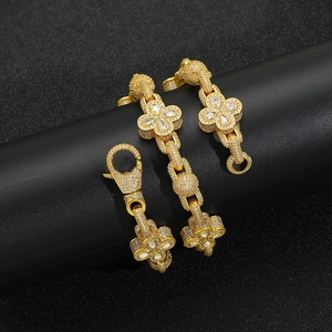 Macro shot of gold hip-hop chain with zircon-studded clovers and large lobster clasp