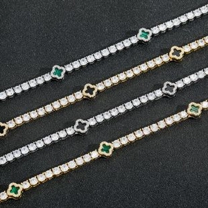 Detail of four-leaf clover tennis bracelets with gold and silver finishes and pavé stones
