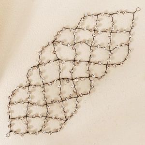 Détail d'un bandeau en résille avec strass délicats et texture de grille métallique