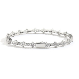 Macro detail of silver cross-patterned bracelet with white pavé-set stones and box clasp