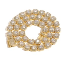 Close-up of gold hip hop chain with square links and round sparkling crystals