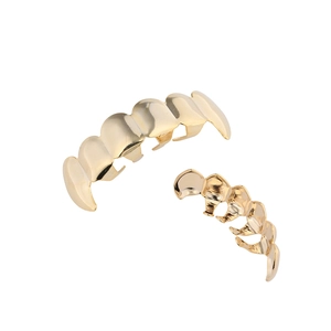 Macro view showing the detailed structure of gold hip-hop vampire teeth grillz for costumes